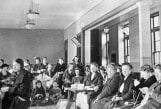 Black and white picture of patients sittng in a big room at Burke from the early twentieth century