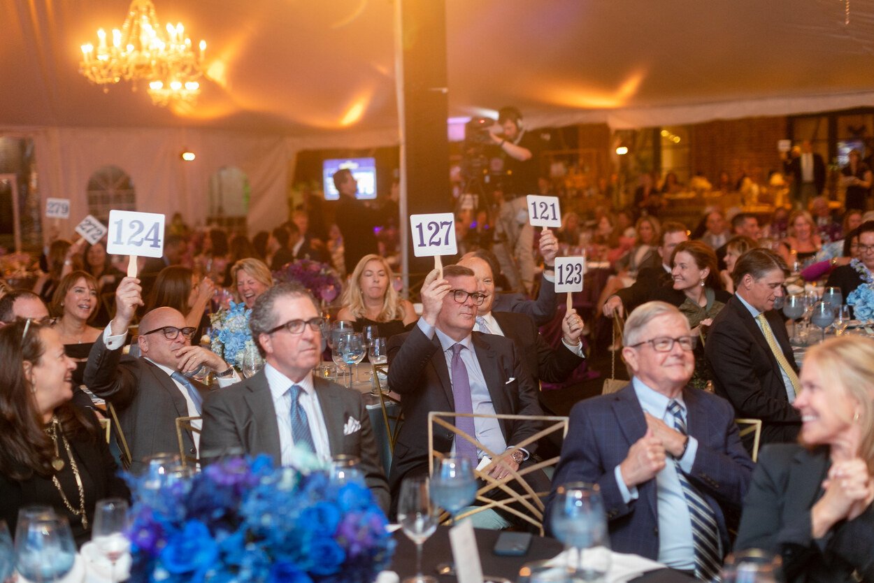 People at table holding paddles