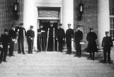 Archival black and white photo of patients standing outside the Billlings building, circa 1920